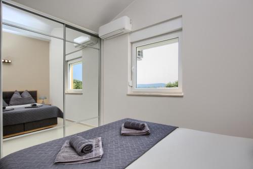 a bedroom with a bed and a mirror at Penthouse Sophia in Medulin