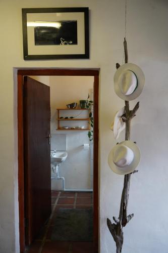 a hallway with a room with a sink and a mirror at The Little Gallery in Villiersdorp