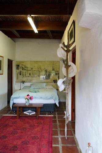 a bedroom with a bed and a table in a room at The Little Gallery in Villiersdorp