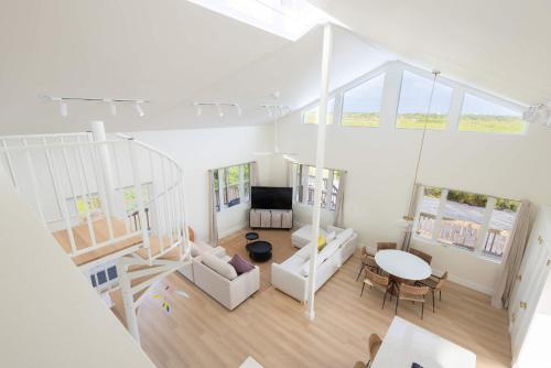 an overhead view of a living room with white furniture at Starlight Serenity - Hideaway with Stunning Views in Pirates Cove