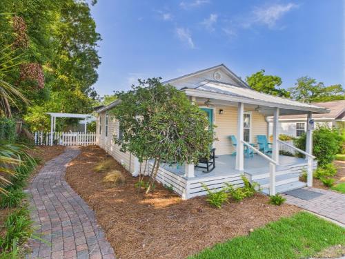 a white house with a porch and a pathway at Coastal Cottage in Port Saint Joe