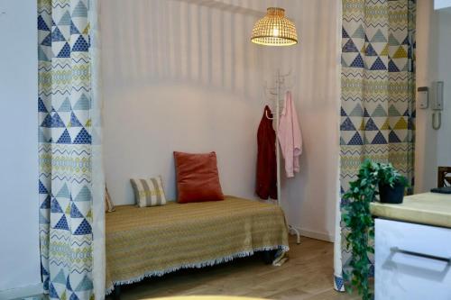 a room with a bed in a room with a sink at Cozy Seaside Apartment in Cullera in Cullera