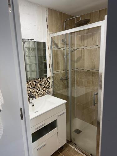 a bathroom with a sink and a shower at Cozy Seaside Apartment in Cullera in Cullera
