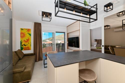 a kitchen and living room with a couch at Apartman Girasole in Trogir