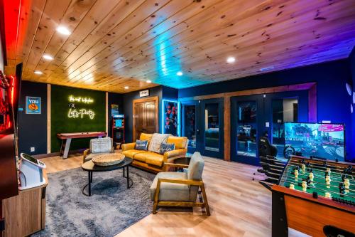 a living room with a pool table and a game room at Heated Pool - Luxury Cabin - Game Room - Theater in Sevierville