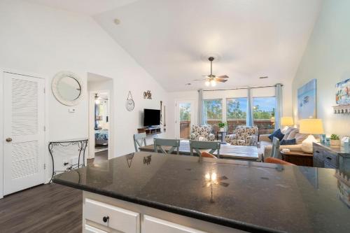 a kitchen and living room with a large counter top at Retreat by Design - Resort Amenities in Branson West