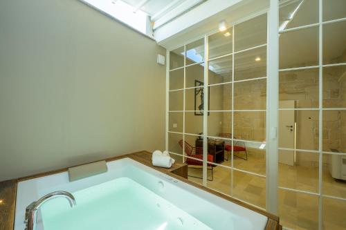a bathroom with a bath tub in a room at Lafornara Suite in Martina Franca