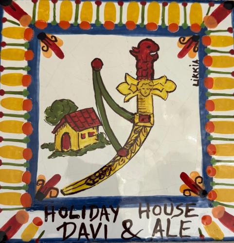 a birthday cake with a drawing of a house and a flag at Holiday house daviale in Schisò