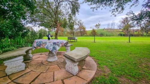 a picnic table and bench in a park at Rivers Edge Loft in Wellington