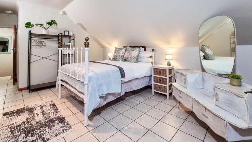 a bedroom with a bed and a large mirror at Rivers Edge Loft in Wellington