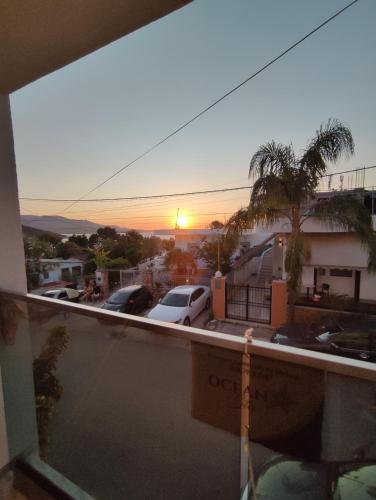 a view from a balcony of a parking lot with a sunset at Galia Apartment in Ksamil