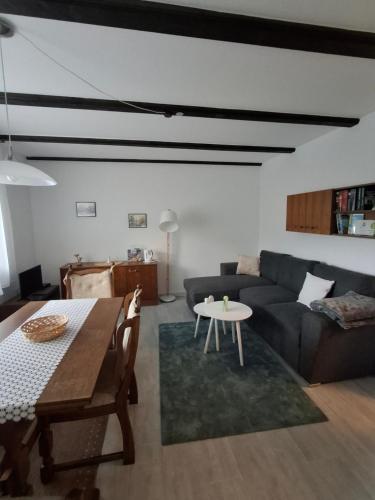 a living room with a couch and a table at Ferienwohnung Natalia in Thalfang