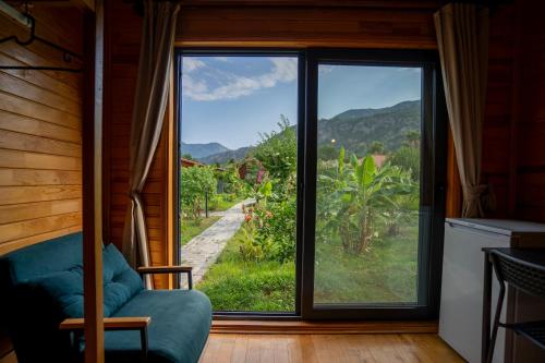 a living room with a large window with a view at Lemon Garden Lodge in Cıralı