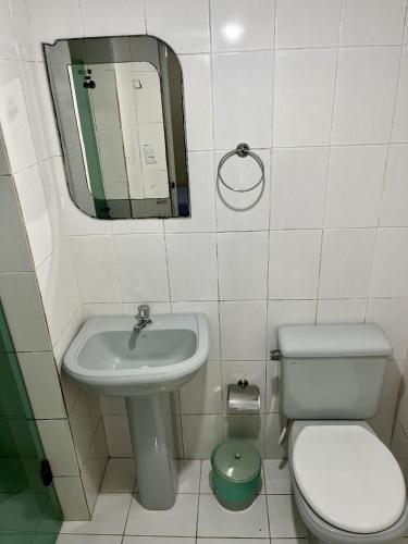 a bathroom with a sink and a toilet and a mirror at Hotel Aeroporto de Congonhas in Sao Paulo