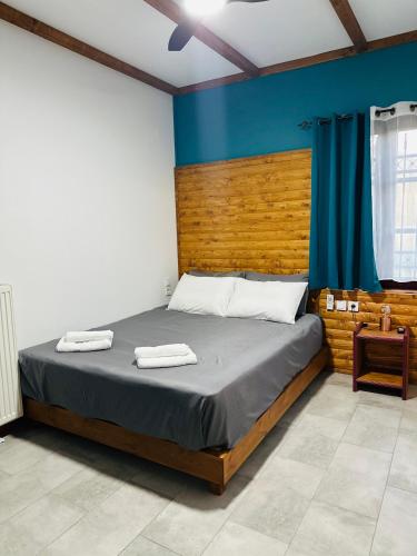 a bedroom with a bed with two towels on it at Λαμπρινής Guest House-Zagori in Asprangeloi