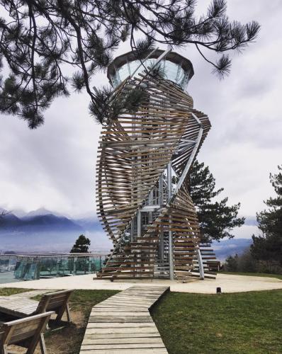 a sculpture of a wooden spiral staircase in a park at The Old Cherry House in Razlog