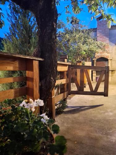 a wooden fence with a tree next to a tree at The Old Cherry House in Razlog