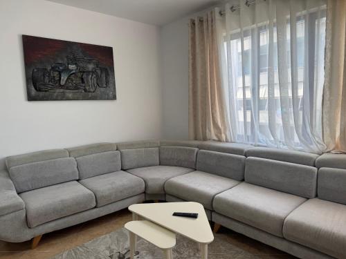 a living room with a couch and a table at Orkidea Apartments in Golem