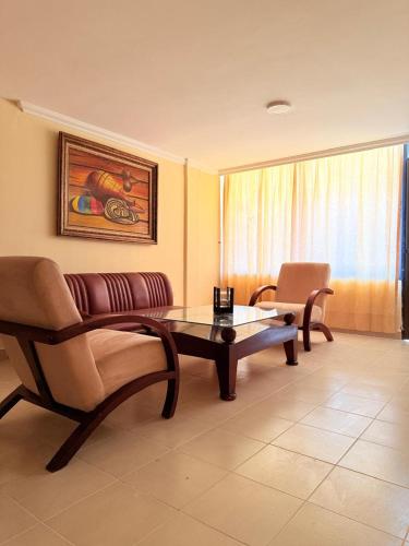 a living room with a couch and a coffee table at Hotel Sorrento 72 in Barranquilla