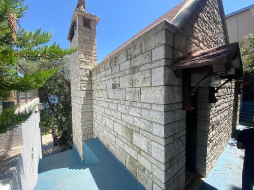 an outdoor brick wall with a chimney on it at Charming 1BR Stone House with Lake View in Bogazici