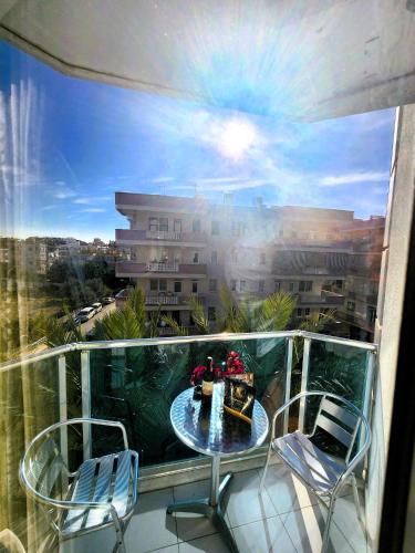 a balcony with a table and chairs and a view of a building at Cleopatra City Hotel Alanya in Alanya