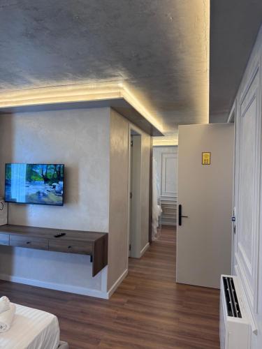 a living room with a tv on the wall at Olea Glass Hotel in Tirane