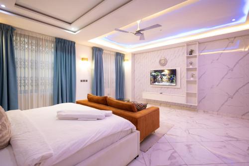 a hotel room with a bed and a couch at Executive Studio Apartment, East Airport in Accra
