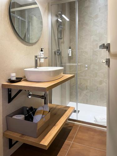 a bathroom with a sink and a shower at Casa Almika Abate Gimma in Bari