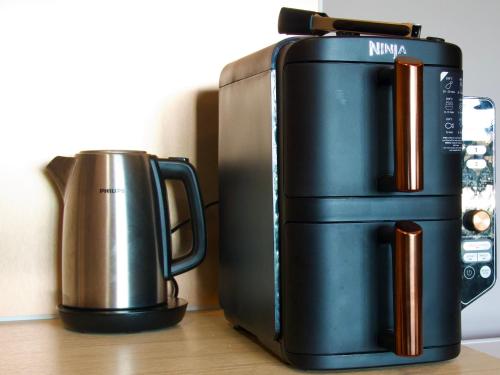 a coffee maker and a kettle on a table at Chalet Calin - Business & Familles in Arzier