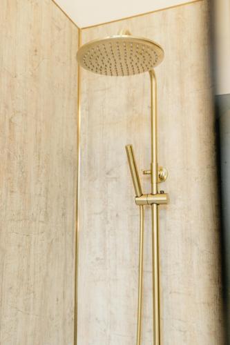 a shower with a shower head in a bathroom at Torr House Hotel in Dumfries