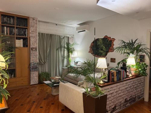 a living room with a couch and lots of plants at Terrazza Milano Apartment in Milan
