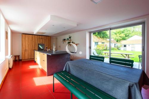 a bedroom with a bed and a large window at COC - Villa La Finca in Audembert