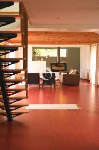 a living room with a red floor and a staircase at COC - Villa La Finca in Audembert