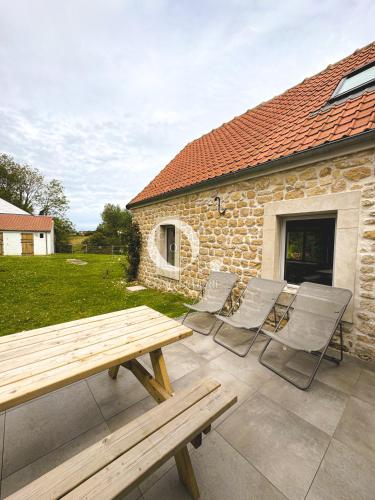 a group of chairs and a picnic table on a patio at COC - Villa La Finca in Audembert