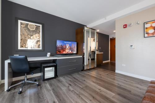 an office with a desk with a monitor and a chair at Godfrey Hotel Chicago in Chicago