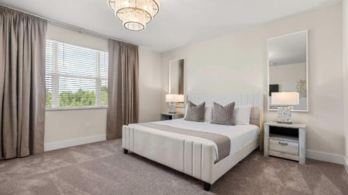 a white bedroom with a large bed and a window at Upstay Pristine 3BR Home with Private Pool & BBQ in Orlando