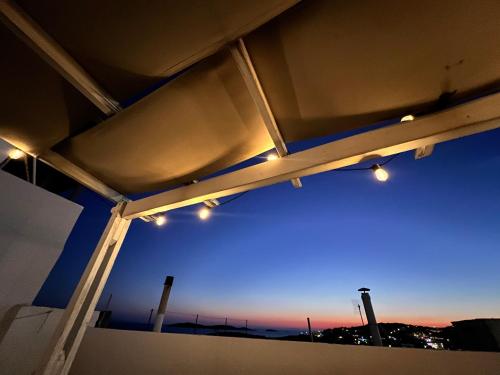 a view of a blue sky from a building with lights at White & Blue in Batsi