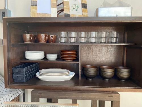 a shelf with bowls and plates on it at Sakaeya - Vacation STAY 76435v in Oshima