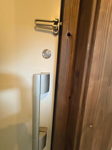 a wooden door with a silver door handle at Sakaeya - Vacation STAY 76435v in Oshima