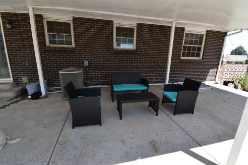 a patio with chairs and tables in front of a brick building at Updated Family Unit with Two King Beds in Denver
