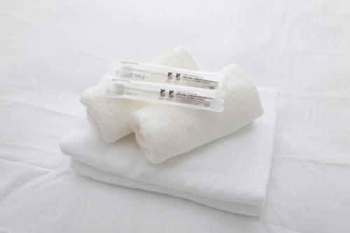 a pile of towels with a price tag on them at Rana Enoshima - Vacation STAY 84717v in Fujisawa