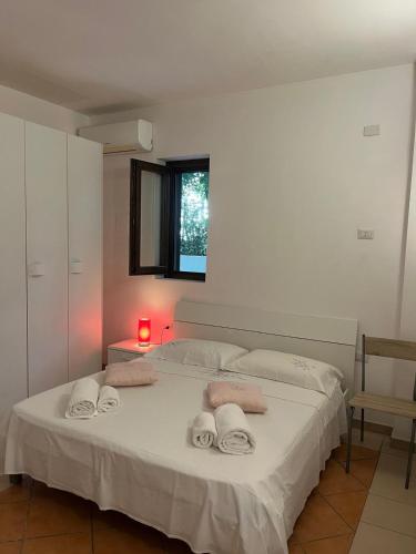 a bedroom with a bed with towels on it at I Tramonti del Salento in Gallipoli