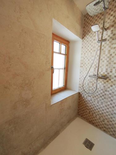 a bathroom with a shower and a window at Maison de charme au cœur d'Ax-Les-Thermes in Ax-les-Thermes