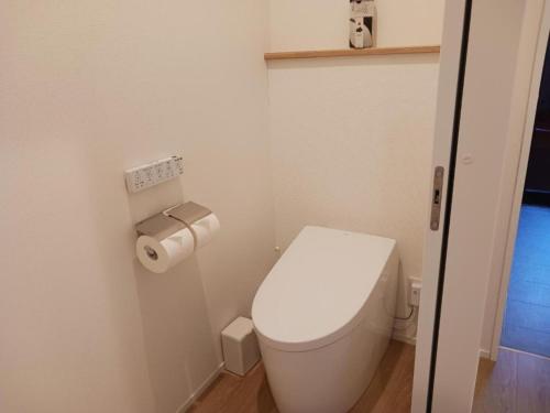 a small bathroom with a toilet and a roll of toilet paper at Kinagashi Happo Chalet - Vacation STAY 23528v in Hakuba