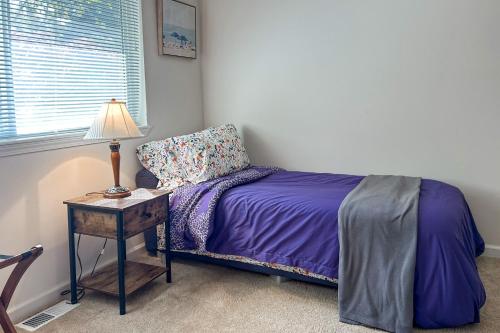 a bedroom with a bed and a table with a lamp at Casa Seaview in Coupeville
