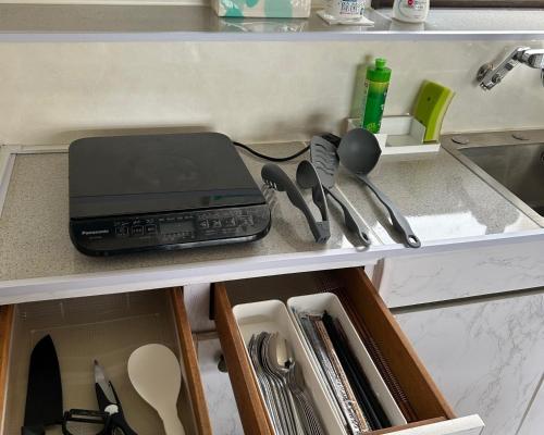a kitchen counter with a drawer with a laptop and utensils at AtreyuーAO - Vacation STAY 35828v in Teshikaga
