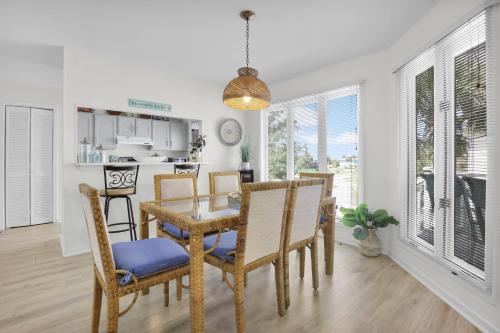 a kitchen and dining room with a table and chairs at Crooked Palm - Marsh Views on Nautical Watch with pool access in Nautical Watch Villas