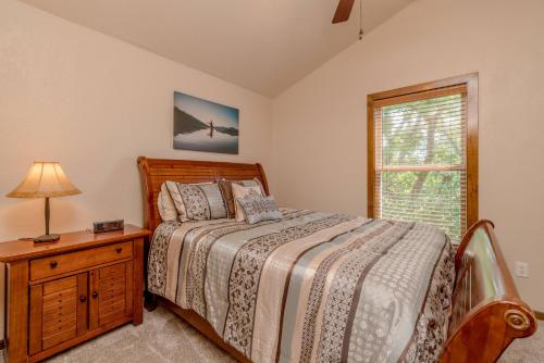 a bedroom with a bed and a lamp and a window at Hickory Hideaway with Communal Pool Access in Hollister
