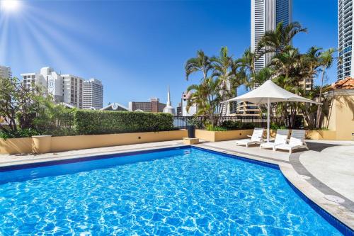 a swimming pool with a view of the city at 'Skyline Oasis' by Inn Paradise in Gold Coast
