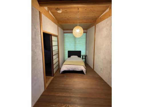 a bedroom with a bed and a television in a room at Tenjin Tabine - Vacation STAY 24240v in Kanazawa